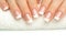 Beautiful fingers with french manicure on the towel. Manicure in