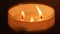 Beautiful fire of a candle in a dark room, a warm yellow candle