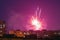 Beautiful fireworks over the roofs of houses