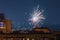 Beautiful fireworks over the roofs of houses