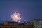 Beautiful fireworks over the roofs of houses