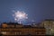 Beautiful fireworks over the roofs of houses