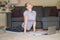 Beautiful fit girl doing yoga exercise on the floor in living room at home. Harmony, balance, meditation, relaxation, healthy