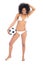 Beautiful fit girl in white bikini holding football smiling at camera