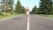 A beautiful fit and healthy blond woman road running down a suburban street in summer sunshine