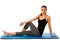 Beautiful fit hispanic woman doing stretching excercise isolated