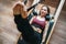 Beautiful fit-shape female dressed sporty doing ABS muscles strength exercises using pilates reformer machine in sport athletic