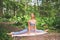 Beautiful fit woman doing stretching split gymnastics with yoga mat, sportswear. Muscular slim attractive girl with flat belly in