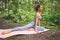 Beautiful fit woman doing stretching split gymnastics with yoga mat, sportswear. Muscular slim attractive girl with flat belly in