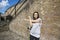 Beautiful fit woman exercising against brick wall