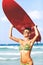 Beautiful fit woman with surfboard on a beach