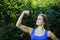 Beautiful fitness girl muscle strain on arm in nature