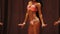 Beautiful fitness model posing on stage in bikini, showing perfect feminine body