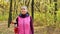 Beautiful fitness sport girl walking along the autumn park in sportswear with sports water bottle or isotonic drink in hand.