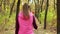 Beautiful fitness sport girl walking along the autumn park in sportswear with sports water bottle or isotonic drink in hand.