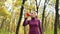 Beautiful fitness sport girl walking along the autumn park in sportswear with sports water bottle or isotonic drink in hand.