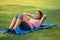 Beautiful  fitness young woman in sportswear doing sit ups on mat in park . sport Fit girl push up exercise in morning . healthy