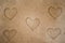 Beautiful Five heart pattern on sand surface for background.