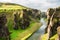 Beautiful Fjadrargljufur canyon with river and big rocks