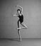 Beautiful flexible ballerina dancing in black swimmwear