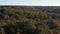 Beautiful flight above the trees. Autumn forest. Yellow, red, green leaves on the trees.