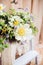 Beautiful floral arrangement with a blossoming buttercup bud close-up.