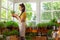 Beautiful florist taking care of a plant.