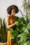 Beautiful florist working looking on leaves