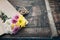 Beautiful flower bouquet wrapped in craft paper on the wooden table background.