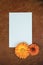 Beautiful flower composition. Mockup with white sheet of paper and orange garden flowers. Summer vintage decor