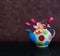 Beautiful flower plumeria or frangipani in fancy baked clay teapot on still life pink dark bokeh background