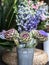 Beautiful flowering decorative branches with artichoke flowers in a metal bucket