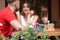 Beautiful flowers and blurred young couple in cafe outdoors