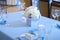 Beautiful flowers and candles on table in wedding day.Blue color decoration tablecloth