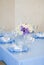 Beautiful flowers and candles on table in wedding day.Blue color decoration tablecloth