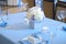 Beautiful flowers and candles on table in wedding day.Blue color decoration tablecloth