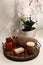 Beautiful flowers and different toiletries on countertop in bathroom