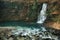 Beautiful flowing mountain waterfall and blue lake in Georgia. Okatse canyon. Martvili canyon