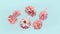 Beautiful flying pastel pink flowers and petals at light blue background, creative floral layout