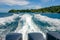 A beautiful foamy trail from a boat with three powerful engines, leaving from Banana Beach of Coral Koh He Island, Thai