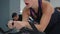 Beautiful focused woman exercising in cycling class