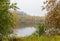 Beautiful fog clad natural lake surrounded by trees and forest in hilly landscape