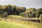 Beautiful fog clad natural lake surrounded by trees and forest in hilly landscape