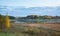 Beautiful fog clad natural lake surrounded by trees and forest in hilly landscape