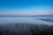 Beautiful fog in mountains before sunrise with forest with moon, Czech Beskydy