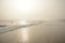 Beautiful foggy beach at sunrise.