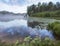 Beautiful foggy morning sunrise on a forest lake with water lilies in summer