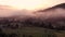 Beautiful foggy sunrise landscape over mountainous countryside.