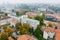 Beautiful foggy Vilnius city scene in autumn with orange and yellow foliage. Aerial early morning view