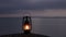 Beautiful footage of old rustic oil lamp silhouette on a rock